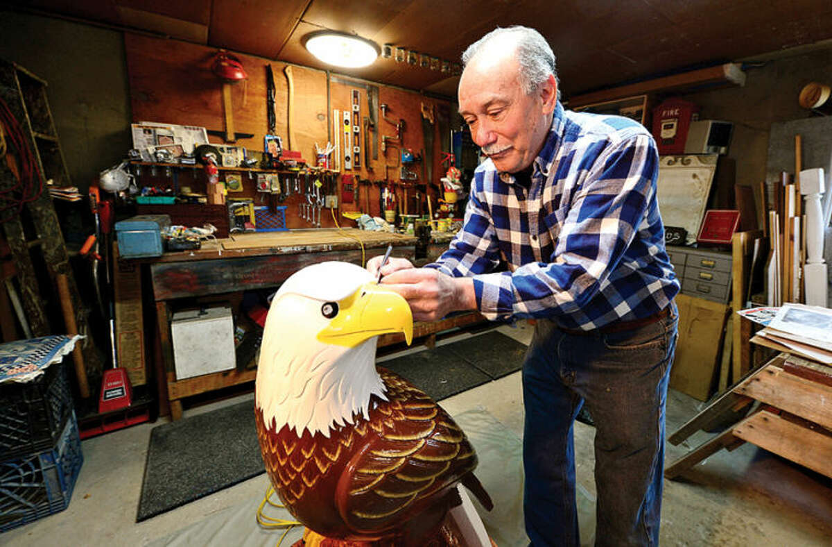 Hour photo / Erik Trautmann Longtime Norwalk resident Mike Caputo, a retired auto body worker, recently took up woodworking and carved a 3-foot eagle out of a 300 pound block of wood.