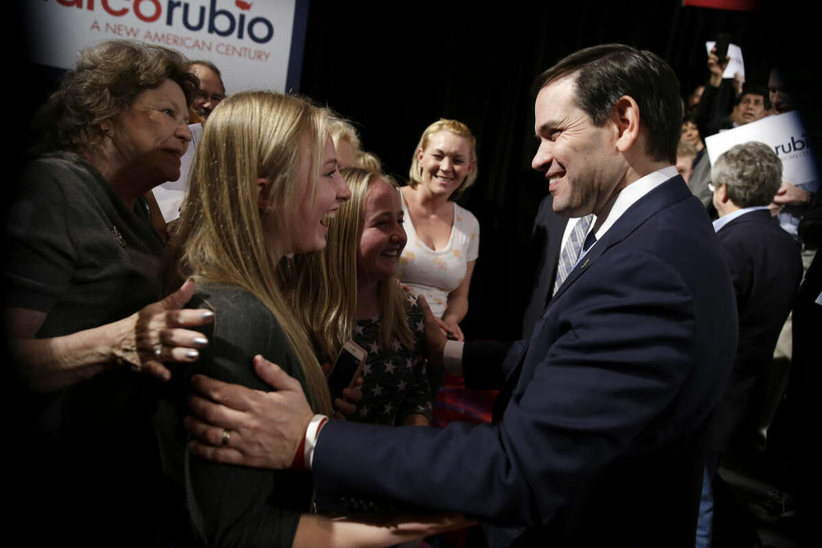 Republican presidential candidate Sen. Marco Rubio, R-Fla, right, greets supporters after speaking at a rally Monday, Feb. 22, 2016, in Reno, Nev. (AP Photo/Marcio Jose Sanchez)