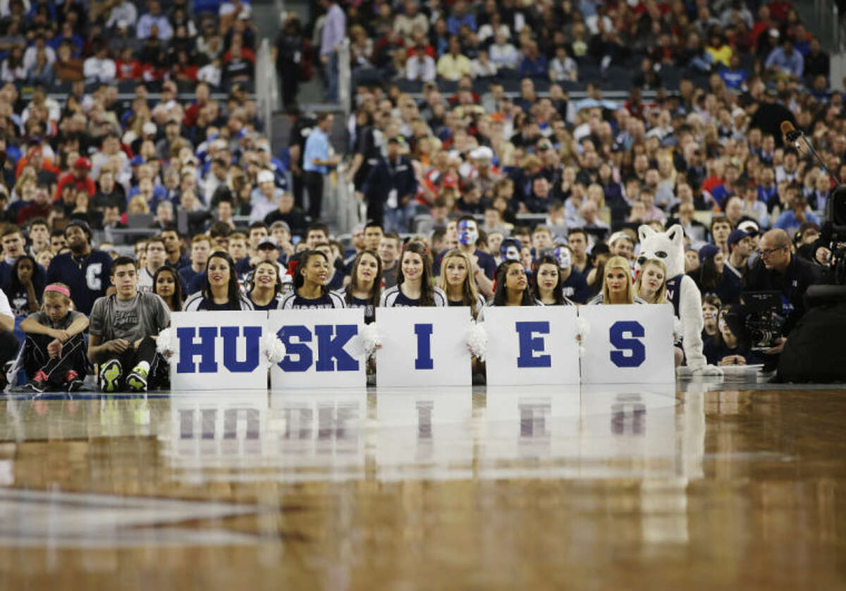Connecticut cheerleaders sit court side during the first half of the NCAA Final Four tournament college basketball semifinal game against Florida Saturday, April 5, 2014, in Arlington, Texas. (AP Photo/David J. Phillip)