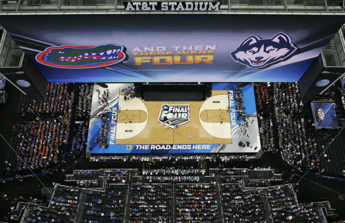 Fans look on during the first half of an NCAA Final Four tournament college basketball semifinal game between Connecticut and Florida Saturday, April 5, 2014, in Arlington, Texas. (AP Photo/David J. Phillip)