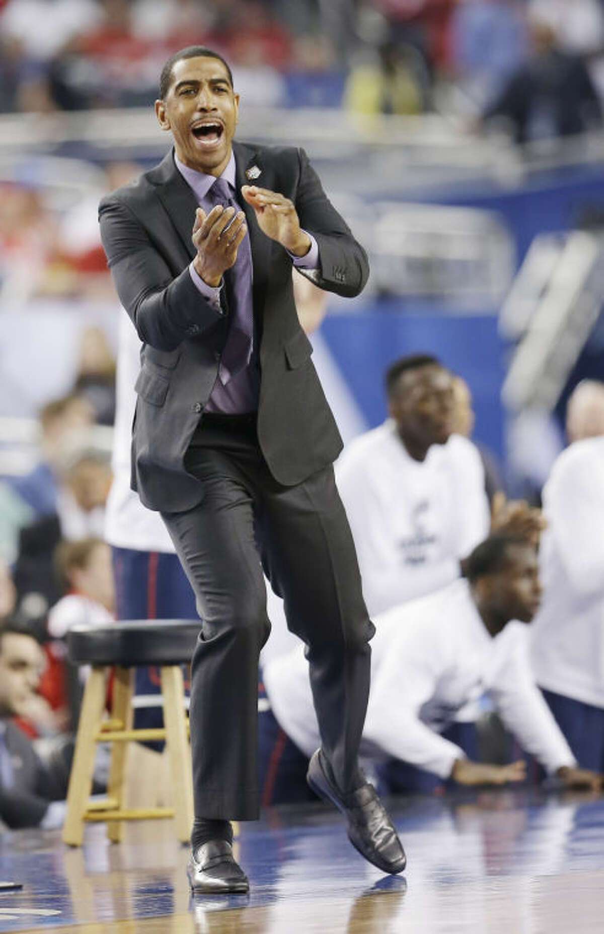 Connecticut head coach Kevin Ollie works the sideline against Florida during the second half of the NCAA Final Four tournament college basketball semifinal game Saturday, April 5, 2014, in Arlington, Texas. (AP Photo/David J. Phillip)