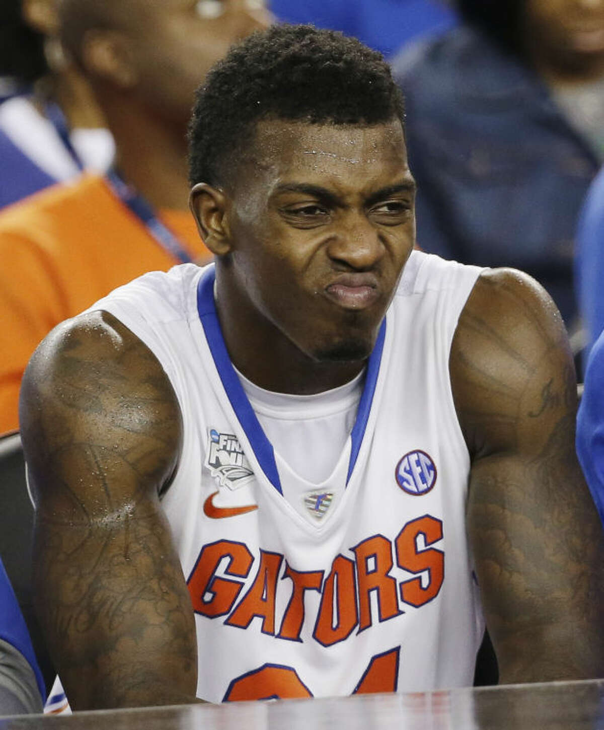 Florida forward Casey Prather (24) frowns as he watches action against Connecticut during the second half of the NCAA Final Four tournament college basketball semifinal game Saturday, April 5, 2014, in Arlington, Texas. (AP Photo/David J. Phillip)