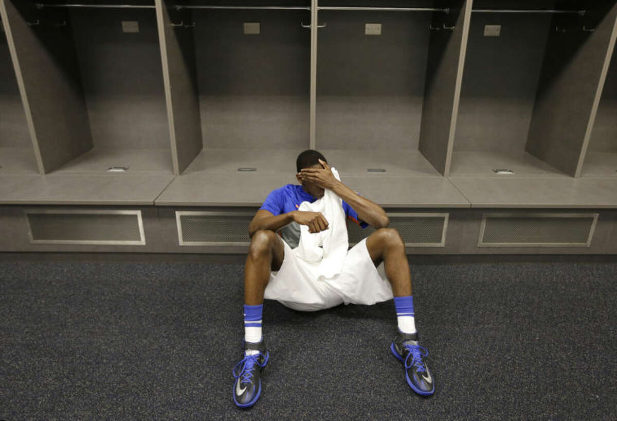 Florida forward Dorian Finney-Smith reacts in the locker room after an NCAA Final Four tournament college basketball semifinal game against Connecticut Saturday, April 5, 2014, in Arlington, Texas. Connecticut won 63-53(AP Photo/Eric Gay)