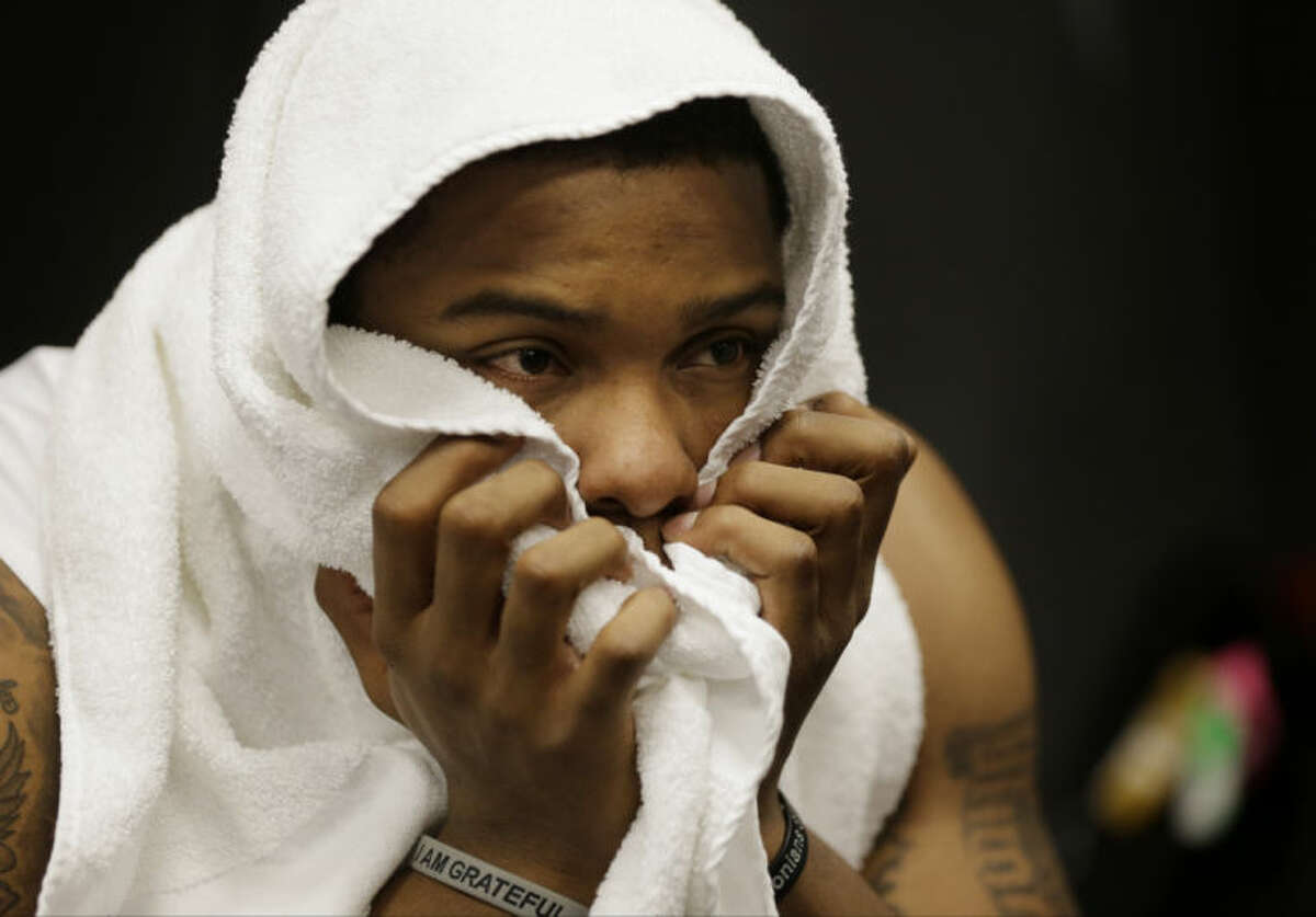 Florida guard Lexx Edwards sits dejected in the lockeroom after his team lost to Connecticut 63-53 at their NCAA Final Four tournament college basketball semifinal game Saturday, April 5, 2014, in Arlington, Texas. (AP Photo/Eric Gay)