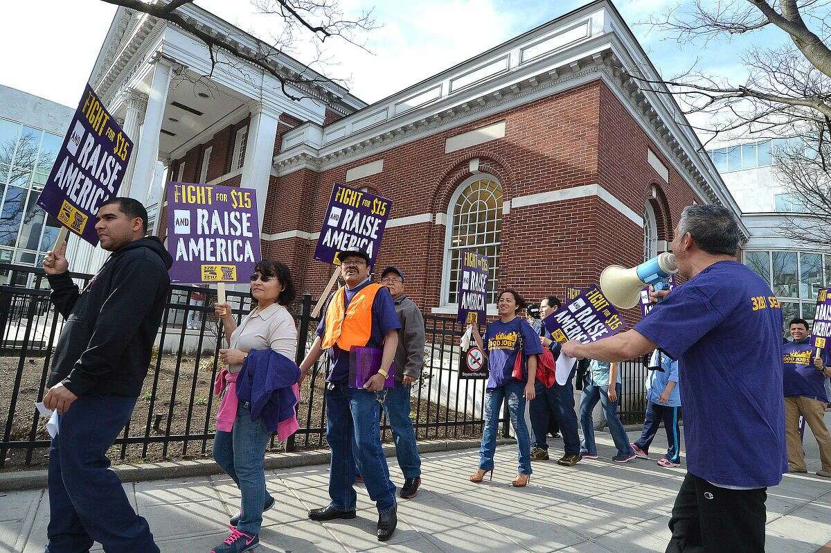 Hour Photo/Alex von Kleydorff Workers unite in downtown Stamford to rally for higher wages and to echo the global wave of protests against wage inequality that has been called the 'Fight for $15'. Members of 32BJ Union in Stamford march as workers across the country mobilize against income inequality.
