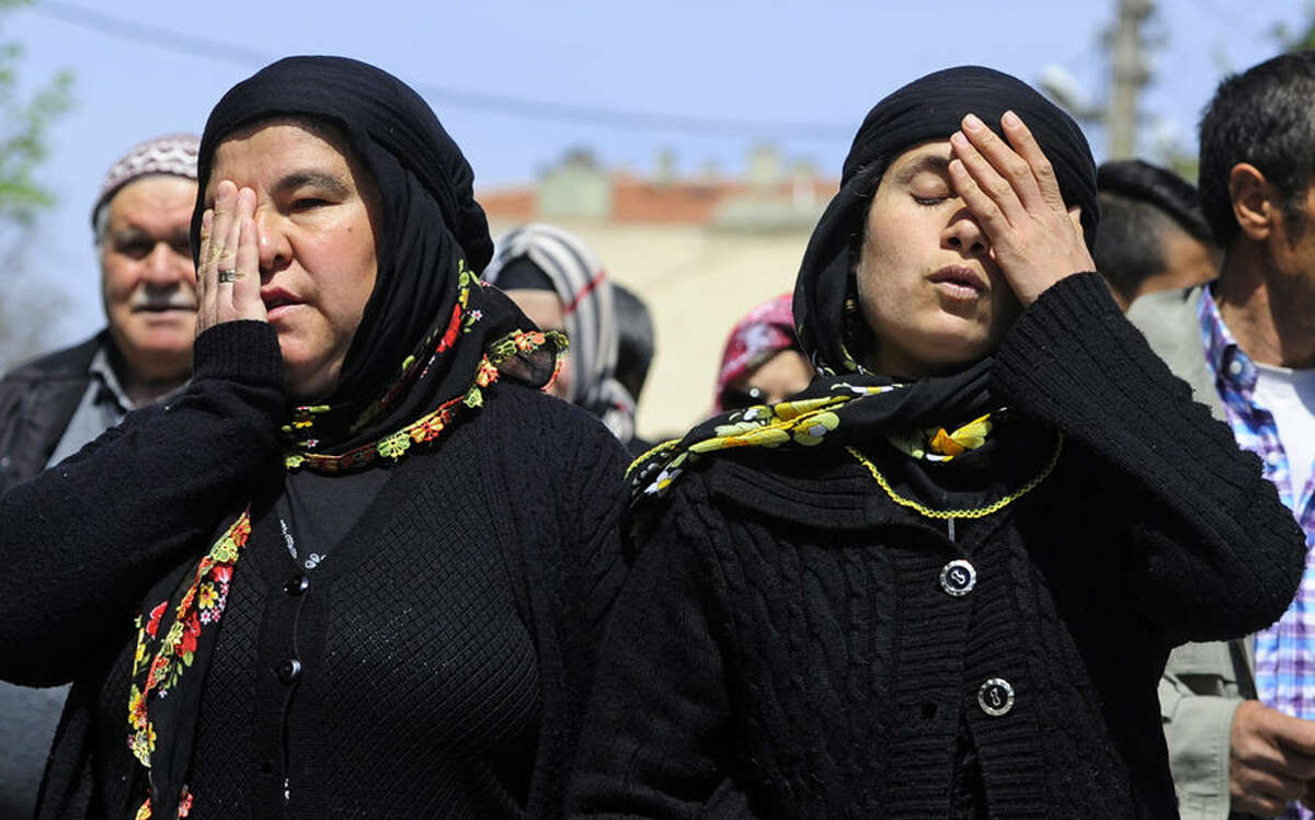 Families of victims of a mine disaster arrive at the trial in Akhisar, Turkey, Wednesday, April 15, 2015. Forty-five managers and employees of a mine in the western Turkish town of Soma, went on trial on Wednesday accused of causing the deaths of 301 miners who perished in a fire last year in Turkey's worst mining disaster.(AP Photo/Emre Tazegul)