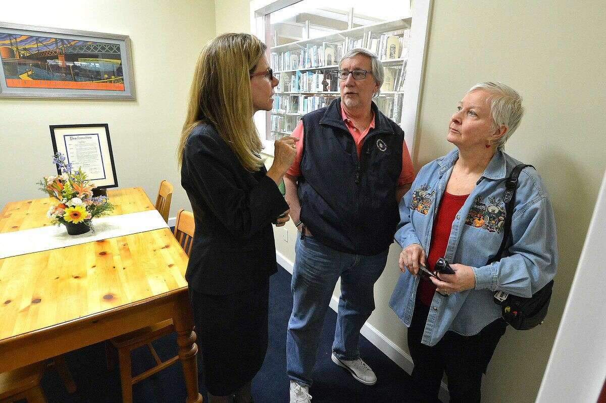 Hour Photo/Alex von Kleydorff Norwalk Public Library Director Christine Bradley talks with Rick McQuade and Marcia Powell in the newly opened Judy's Room, dedicated to Judy Rivas at The Norwalk Library