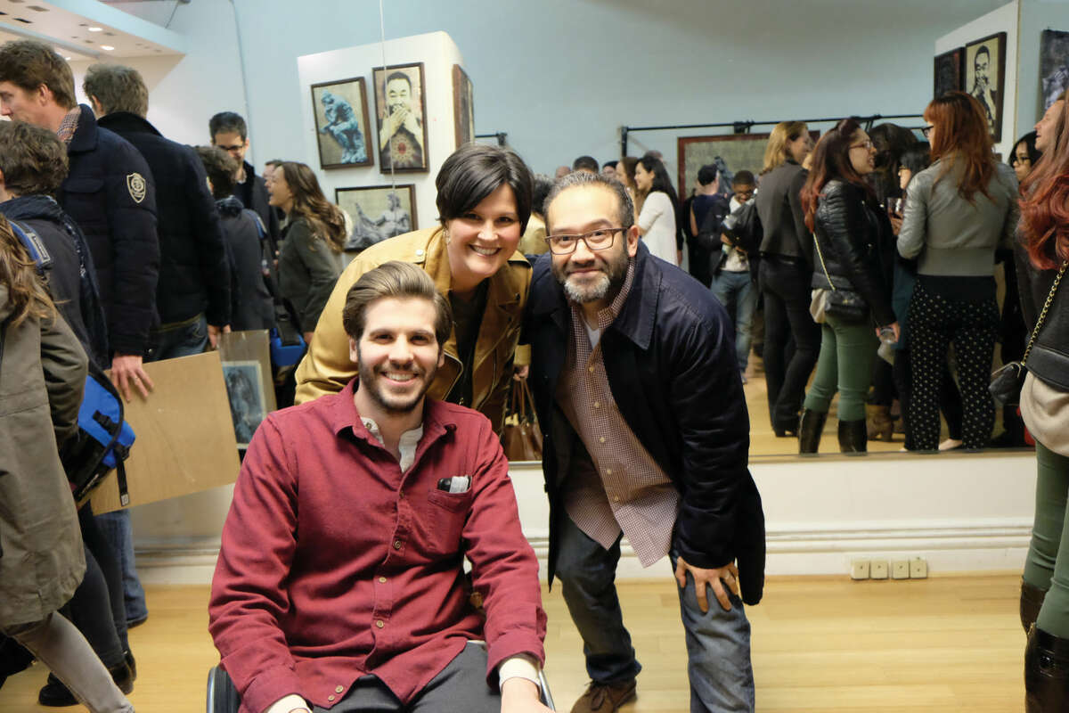 A pole vaulting accident left Wilton native B.D. White paralyzed. Despite his injury, the budding artist is shaking up the New York City art scene. Here White poses with two New York art buyers during a recent showcase. 