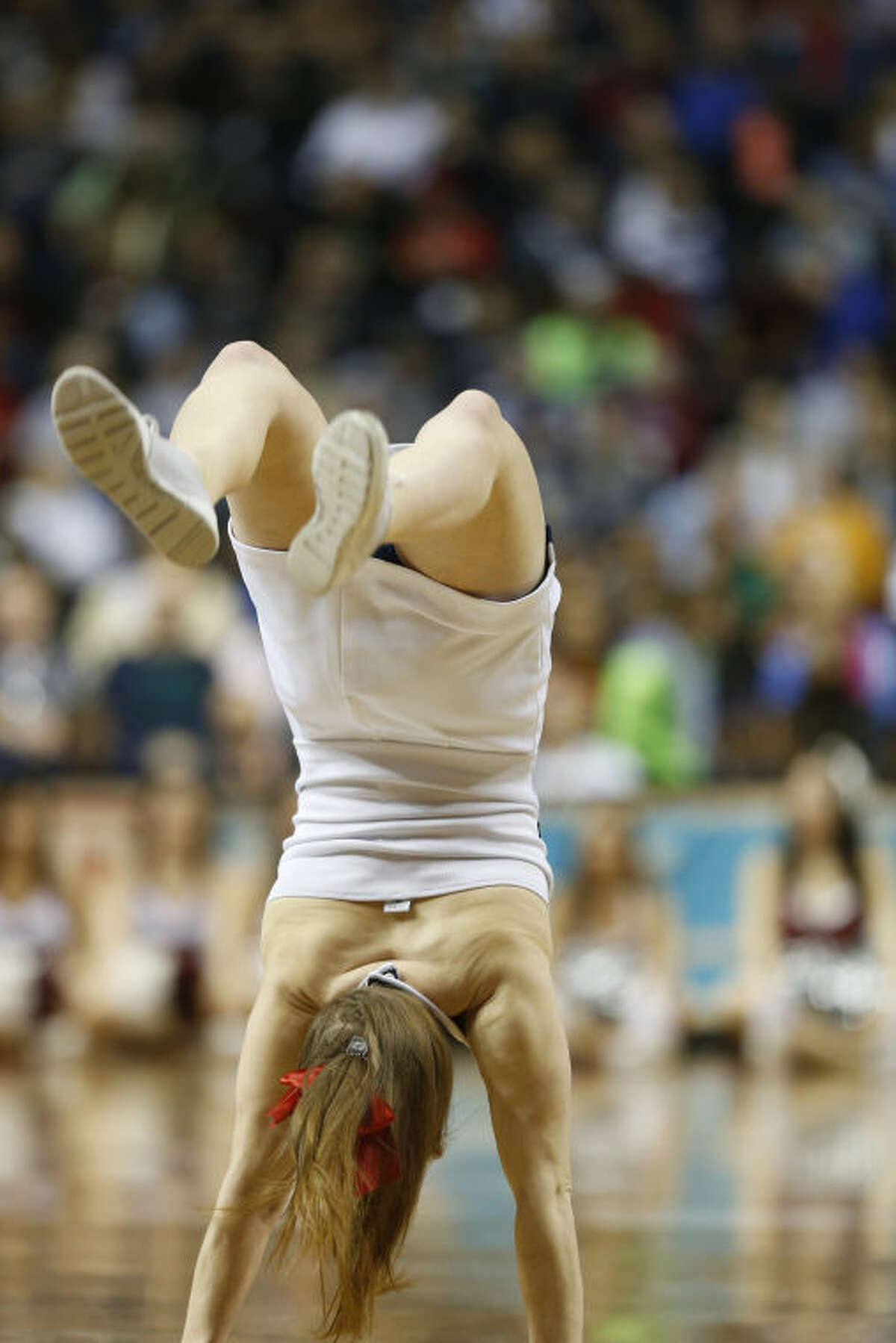 Connecticut cheerleaders perform against Stanford during the first half of the semifinal game in the Final Four of the NCAA women's college basketball tournament, Sunday, April 6, 2014, in Nashville, Tenn. (AP Photo/John Bazemore)