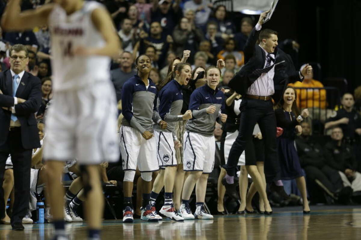 The Connecticut bench cheers a basket against Stanford during the first half of the semifinal game in the Final Four of the NCAA women's college basketball tournament, Sunday, April 6, 2014, in Nashville, Tenn. (AP Photo/Mark Humphrey)