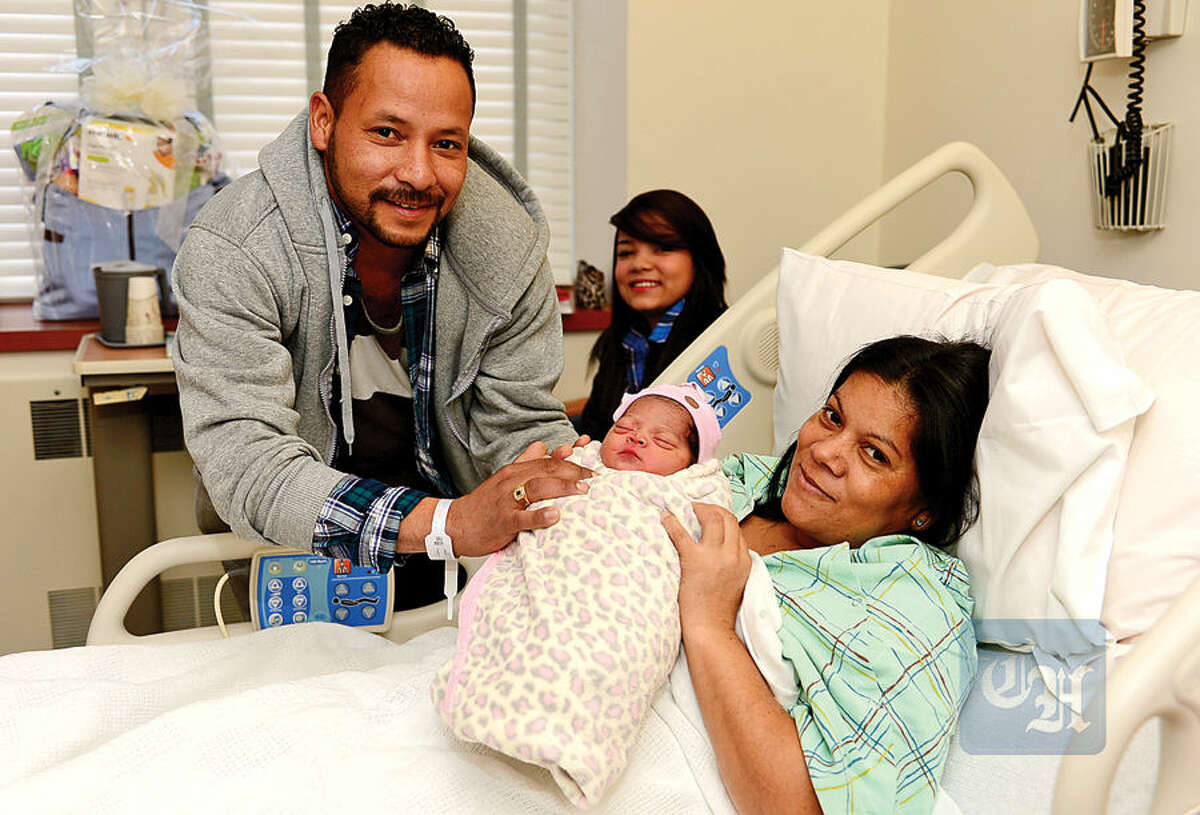 Hour photo / Erik Trautmann Dimas Amaya, Dawn Ayama-Rodriguez and Nora Rodriguez celebrate the birth of a new addition to their family, Ella Amaya-Rodriguez, who was the first baby born in Norwalk this year.