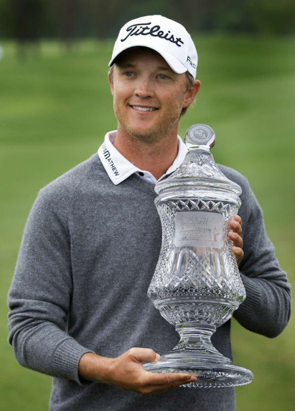 Matt Jones holds the championship trophy after winning the Houston Open golf tournament on Sunday, April 6, 2014, in Humble, Texas. (AP Photo/Patric Schneider)
