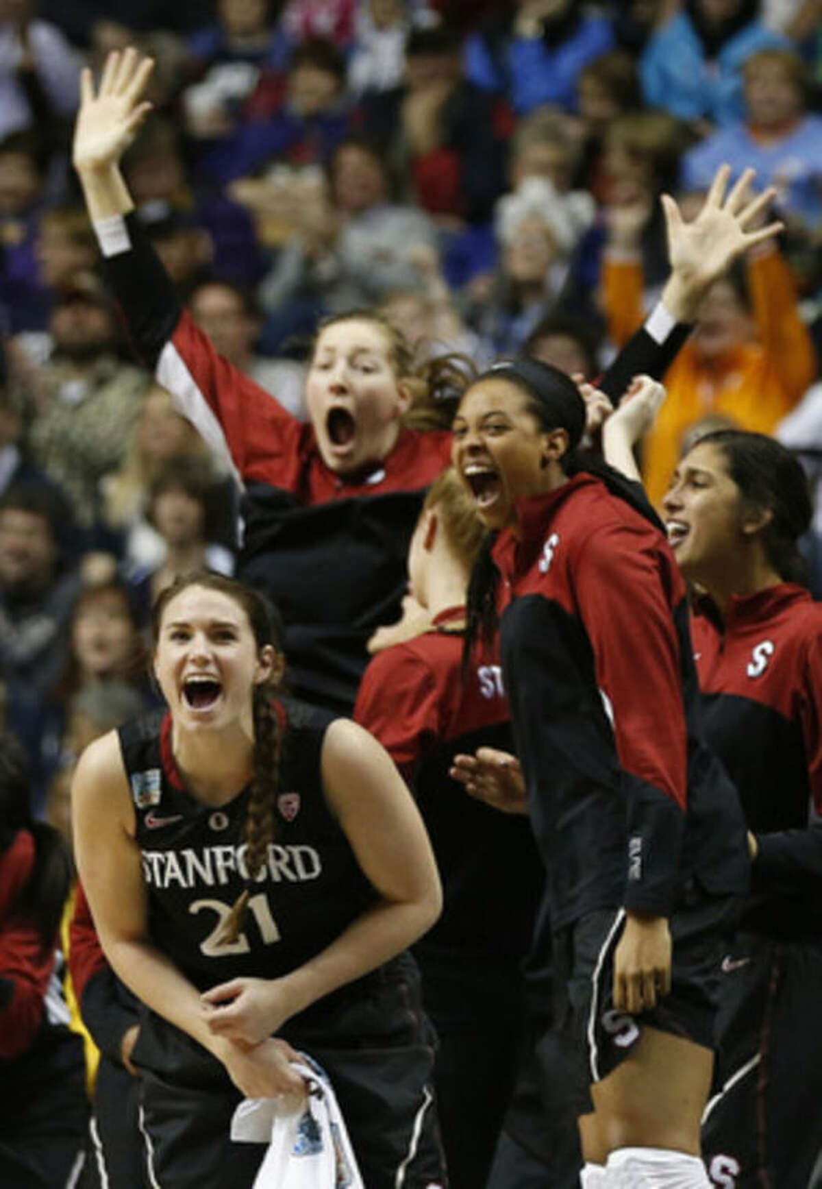 Stanford players celebrate a three-point shot against Connecticut during the first half of the semifinal game in the Final Four of the NCAA women's college basketball tournament, Sunday, April 6, 2014, in Nashville, Tenn. (AP Photo/John Bazemore)