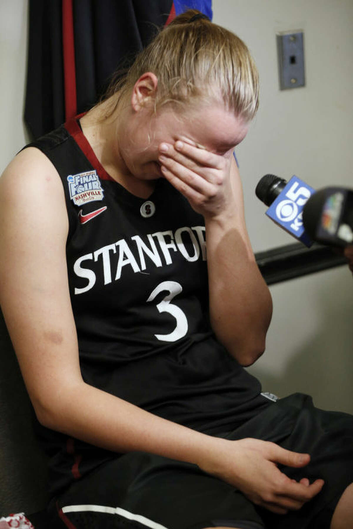 Stanford forward Mikaela Ruef sits in the locker room after the second half of the semifinal game against Connecticut in the Final Four of the NCAA women's college basketball tournament, Sunday, April 6, 2014, in Nashville, Tenn. Connecticut won 75-56. (AP Photo/John Bazemore)