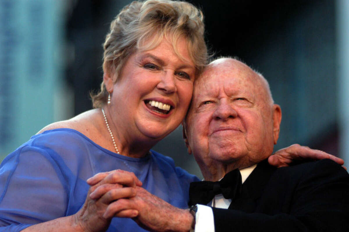 FILE - In this Monday, April 26, 2004, file photo, Jan, left, and Mickey Rooney pose for photographs after having unveiled their star on the Hollywood Walk of Fame in Los Angeles. Mickey Rooney, a Hollywood legend whose career spanned more than 80 years, has died. He was 93. Los Angeles Police Commander Andrew Smith said that Rooney was with his family when he died Sunday, April 6, 2014, at his North Hollywood home. (AP Photo/Ann Johansson, File)