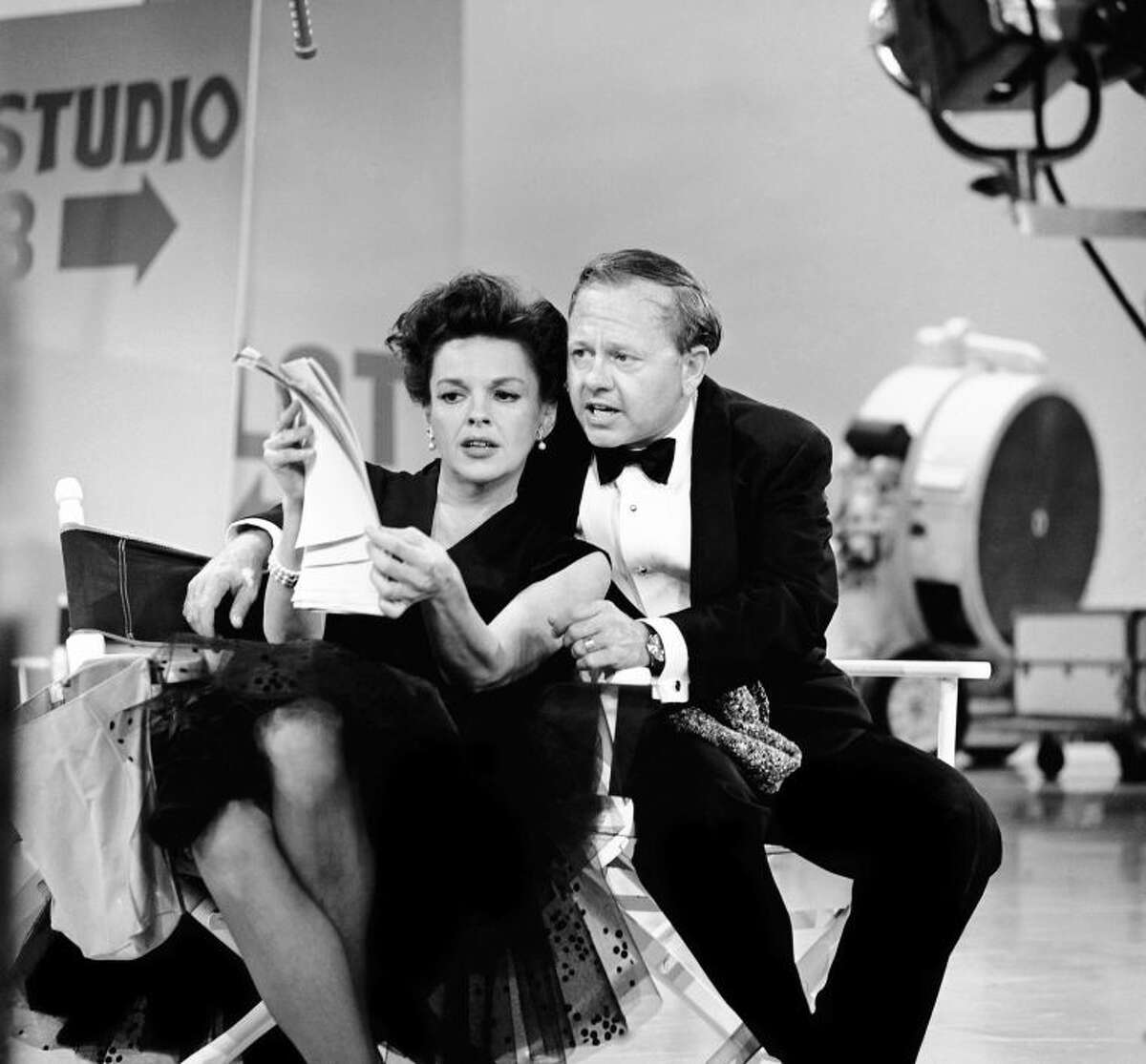 FILE - In this June 26, 1963, file photo, Judy Garland and Mickey Rooney put their heads together over a television script for their first onstage reunion in 18 years, for the taping of the first of 32 variety shows which Garland will do for CBS next season. Rooney, a Hollywood legend whose career spanned more than 80 years, has died. He was 93. Los Angeles Police Commander Andrew Smith said that Rooney was with his family when he died Sunday, April 6, 2014, at his North Hollywood home. (AP Photo/File)