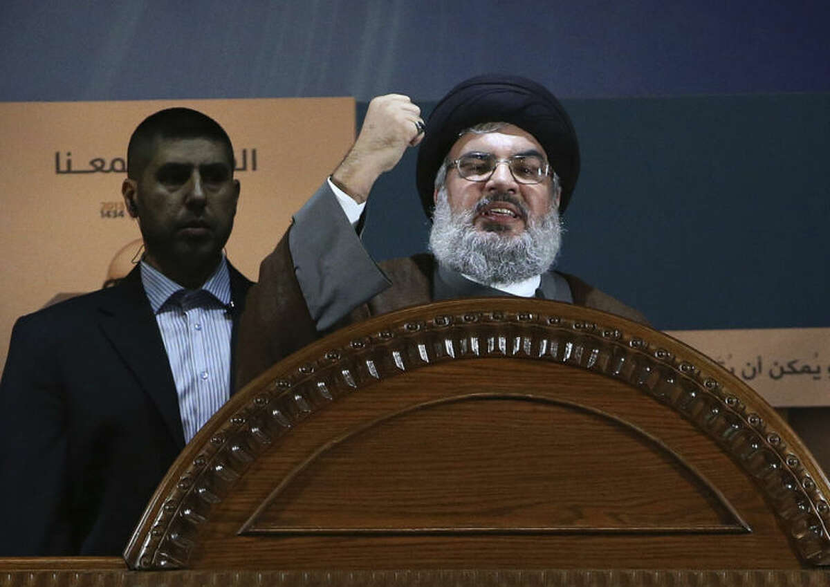 FILE - In this August 2, 2013, file photo, Hezbollah leader Sheik Hassan Nasrallah speaks during a rally to mark Jerusalem day, or Al-Quds day, in the southern suburb of Beirut, Lebanon. The government of Syrian President Bashar Assad is no longer in danger of falling, Nasrallah, the leader of Lebanon's militant Hezbollah group, said in interview with Lebanon's daily As-Safir newspaper published Sunday, April 6, 2014. (AP Photo/Hussein Malla, File)