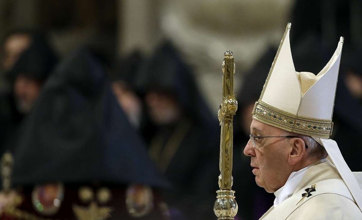 Pope Francis arrives to celebrates an Armenian-Rite Mass on the occasion of the commemoration of the 100th anniversary of the Armenian Genocide, in St. Peter's Basilica, at the Vatican Sunday, April 12, 2015. Historians estimate that up to 1.5 million Armenians were killed by Ottoman Turks around the time of World War I, an event widely viewed by genocide scholars as the first genocide of the 20th century. Turkey however denies that the deaths constituted genocide, saying the toll has been inflated, and that those killed were victims of civil war and unrest. (AP Photo/Gregorio Borgia)