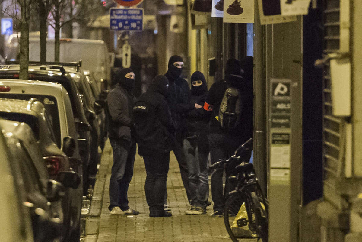 Police investigate an area where terror suspect Mohamed Abrini was arrested earlier today, in Brussels on Friday April 8, 2016. The federal prosecutor's office confirmed a fugitive suspect in the Nov. 13 Paris attacks was arrested in Belgium on Friday, after a raid Belgian authorities said was linked to the deadly March 22 Brussels bombings. The suspect, Mohamed Abrini, is believed to be the mysterious "man in the hat" who escaped the double bombing at Brussels airport, but further investigation is needed to determine Abrini is the third suspect of the airport attack. (AP Photo/Geert Vanden Wijngaert)