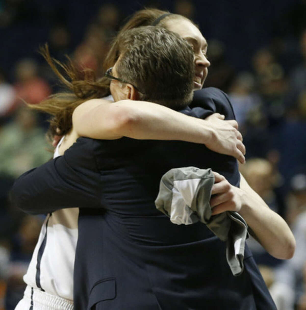 Connecticut forward Breanna Stewart embraces Connecticut head coach Geno Auriemma after the second half of the semifinal game against Stanford in the Final Four of the NCAA women's college basketball tournament, Sunday, April 6, 2014, in Nashville, Tenn. Connecticut won 75.56. (AP Photo/John Bazemore)