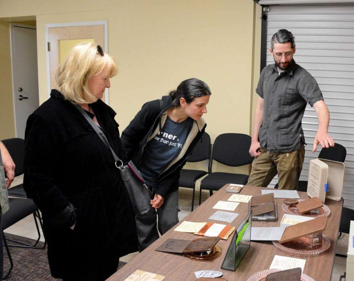 Guests at a kickstarter fundraiser for Noteworthy Chocolates takes a look at their display samples on Thursday April 14 2016.