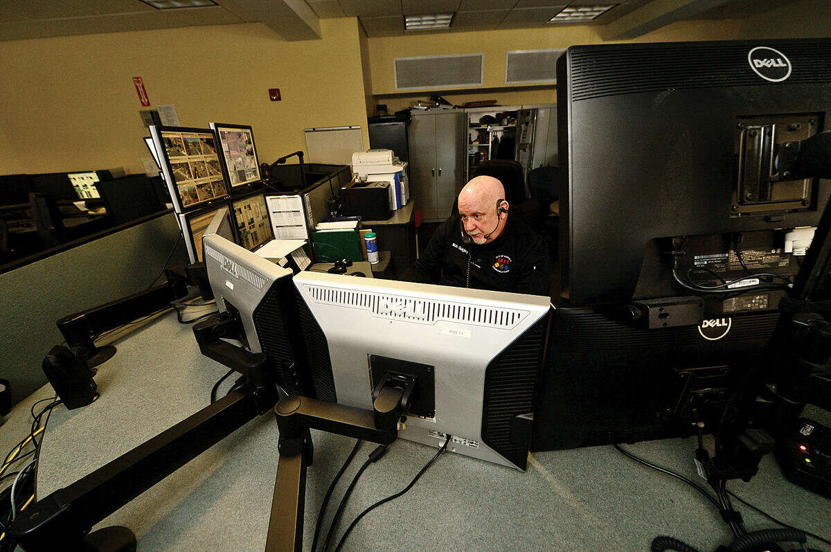 Emergency Dispatch Supervisor Bob Quigley takes calls in the third-floor dispatch office at Norwalk Police Department Friday, April 15, 2016.