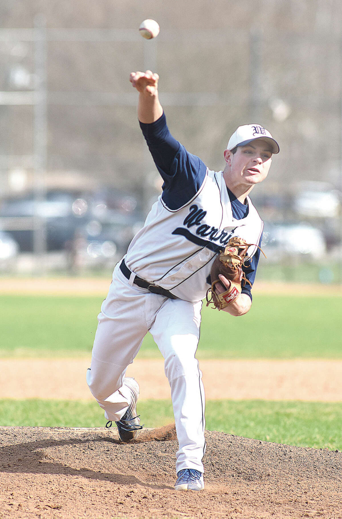 Hour photo/John Nash - Wilton pitcher Jackson Ward fires to the plate during Monday's game against Greenwich. Ward, who pitched a no-hitter in the season-opener, gave up two unearned runs in a hard-luck 2-1 loss to the Cardinals.