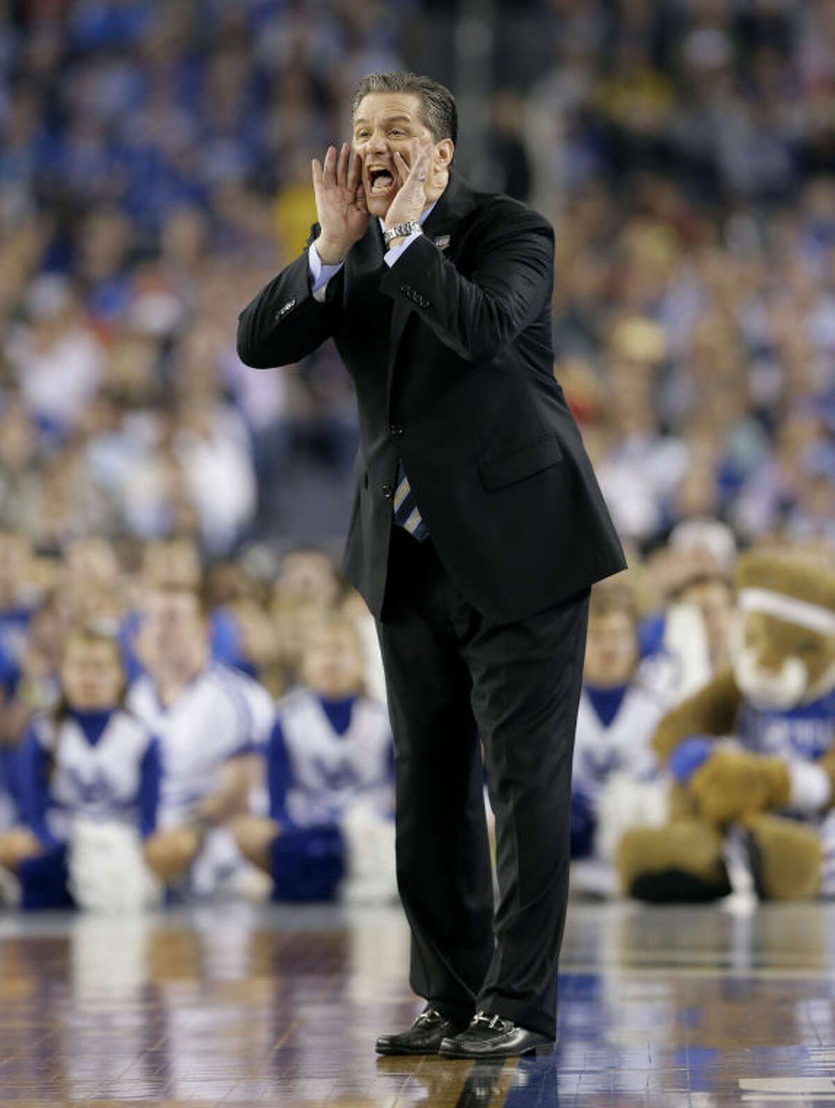 Kentucky head coach John Calipari shouts to his team during the first half of the NCAA Final Four tournament college basketball championship game against Connecticut Monday, April 7, 2014, in Arlington, Texas. (AP Photo/Eric Gay)