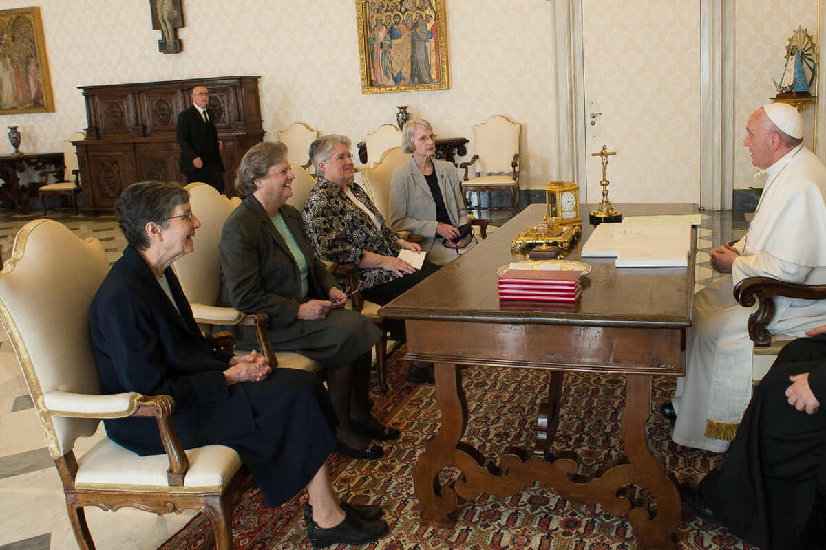 Pope Francis, right, talks with a delegation of The Leadership Conference of Women Religious during an audience in the pontiff's studio at the Vatican, Thursday, April 16, 2015. The Vatican has announced the unexpected conclusion of a controversial overhaul of the main umbrella group of US nuns in a major shift in tone and treatment of American nuns under the social justice-minded Pope Francis. (L’Osservatore Romano/Pool Photo via AP)