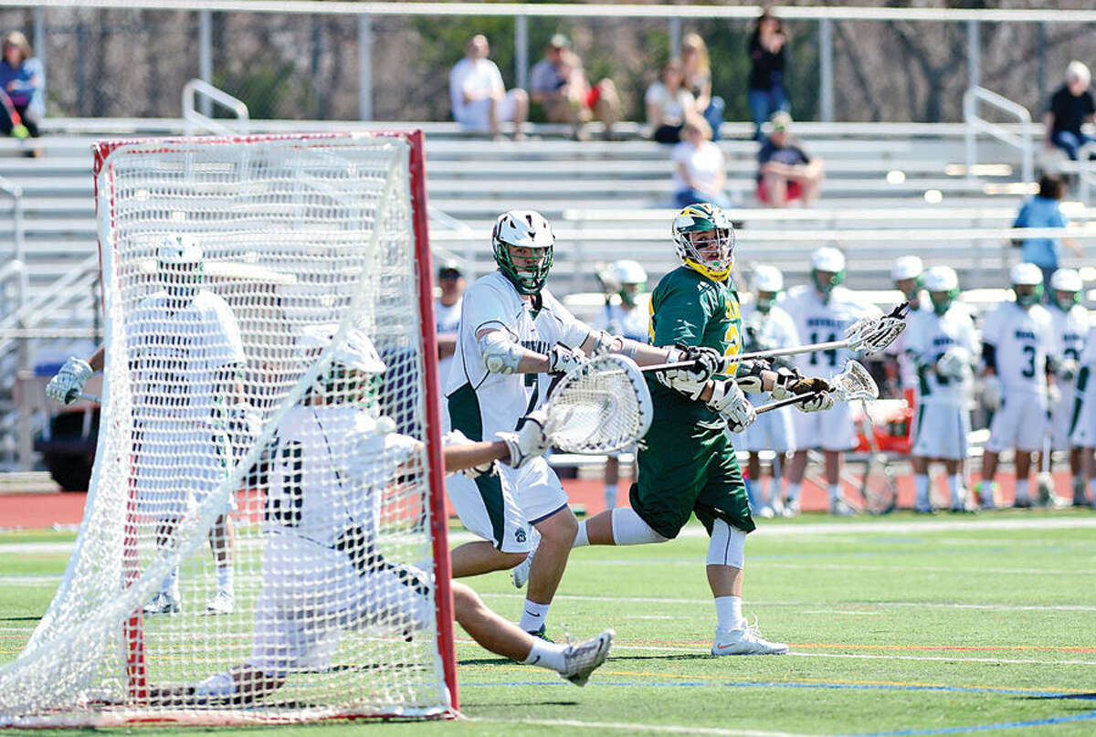 Hour photo / Erik Trautmann Trinity Catholic's #2 watches his shot go in the goal during their lacrosse game against NorwalkSaturday