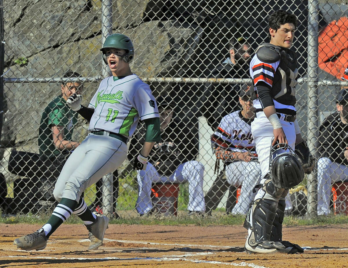 Stamford catcher Nico Kydes reacts as Norwalk Moe Ortiz-Echevarria celebrates scoring in the first inning of a FCIAC boys baseball game at Stamford High School on April 15, 2016. Norwalk defeated Stamford 8-7.