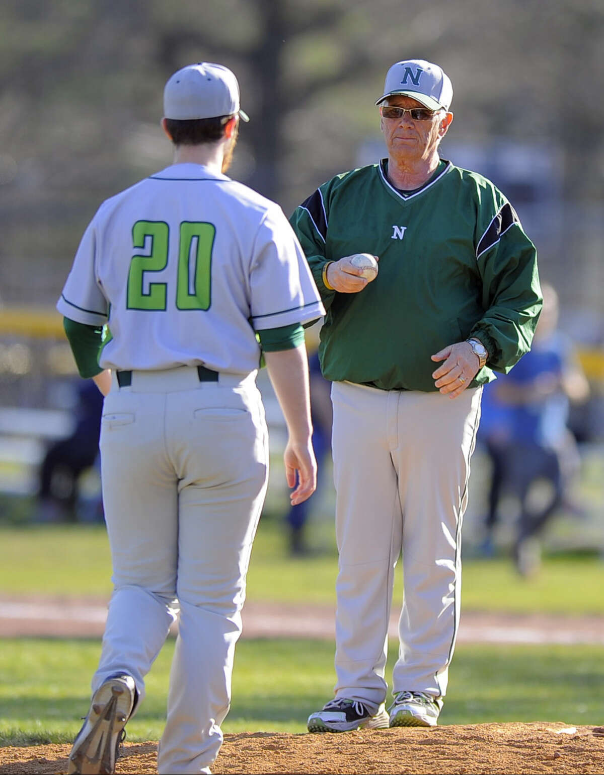 Norwalk coach Pete Tucci hands off the pitching against Stamford to Kyle Pisacrita after pulling starting pitcher Isaac Keehn in the fourth inning of a FCIAC boys baseball game at Stamford High School on April 15, 2016. Norwalk defeated Stamford 8-7.