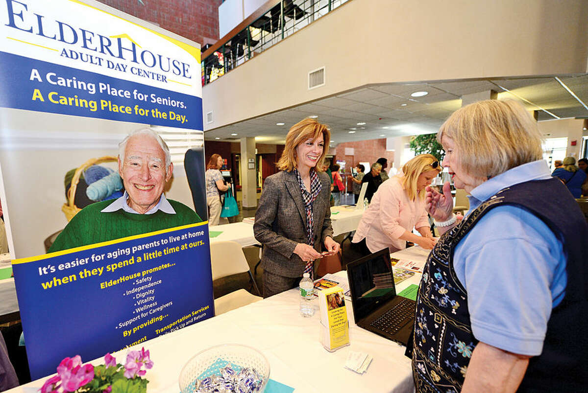 Hour photo / Erik Trautmann Elderhouse Executive Director Denise Cesareo chats with Anne Richards during the Norwalk Leadershp Institute Senior Expo Project at the Norwalk Community College where over 25 tables were hosted by local non profit and for profit organizations that provide critical services to Norwalk seniors.