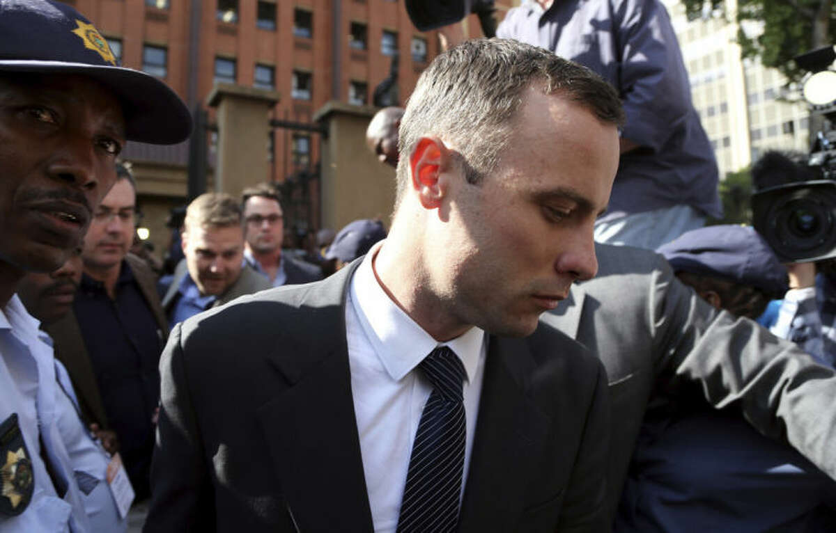 Oscar Pistorius, leaves the high court in Pretoria, South Africa, Tuesday, April 8, 2014. Pistorius is charged with murder for the shooting death of his girlfriend, Reeva Steenkamp, on Valentines Day in 2013. (AP Photo/Themba Hadebe)
