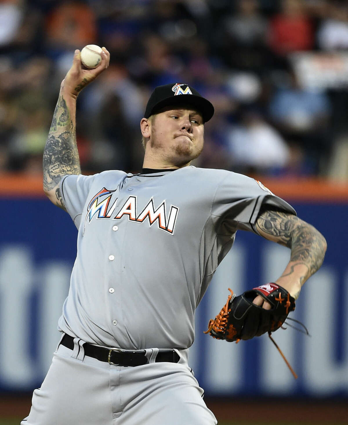 Miami Marlins starter Mat Latos pitches against the New York Mets in the first inning of a baseball game at Citi Field on Saturday, April 18, 2015, in New York. (AP Photo/Kathy Kmonicek)