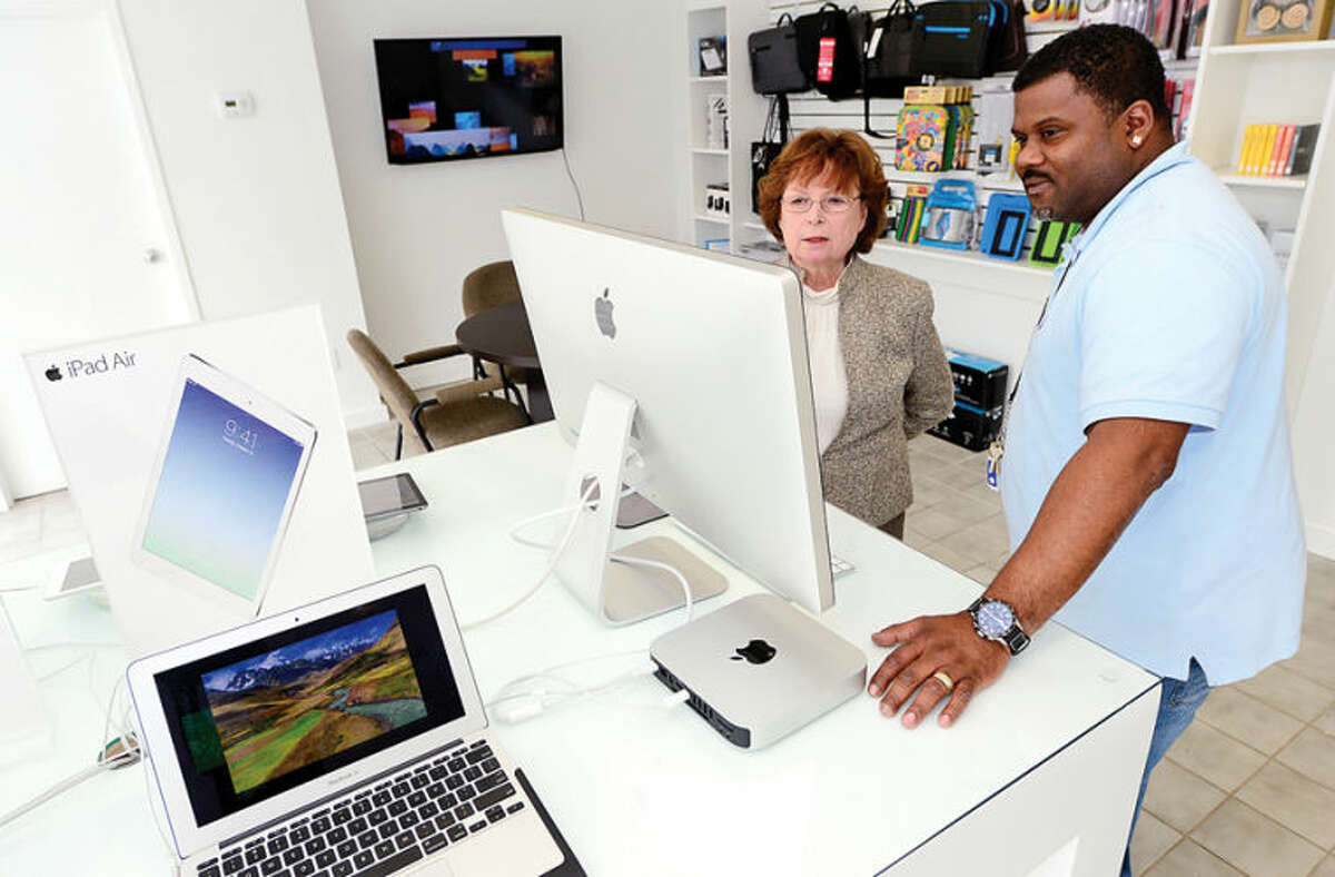Hour photo / Erik Trautmann TBI Computer owner Judy O'Meara and Sales Repersentative Dion Francis in stores new Westport Ave location.