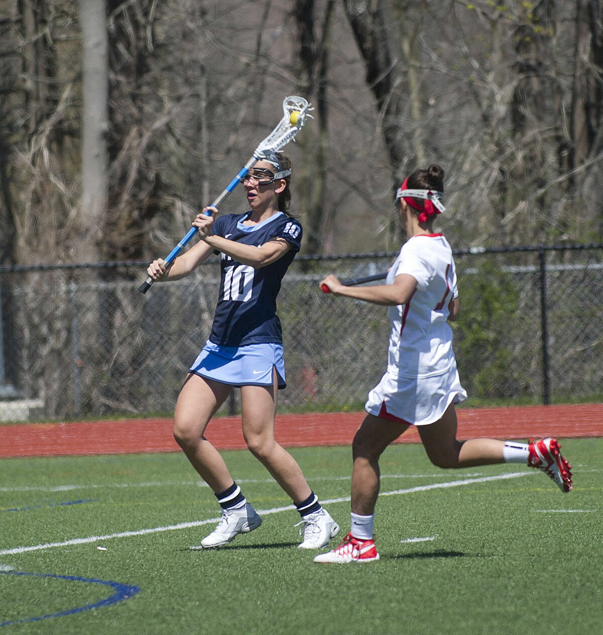 Wilton's Lilla Seymour controls the ball during Saturday's girls lacrosse game against Wilton at Greenwich High School on April 16, 2016.