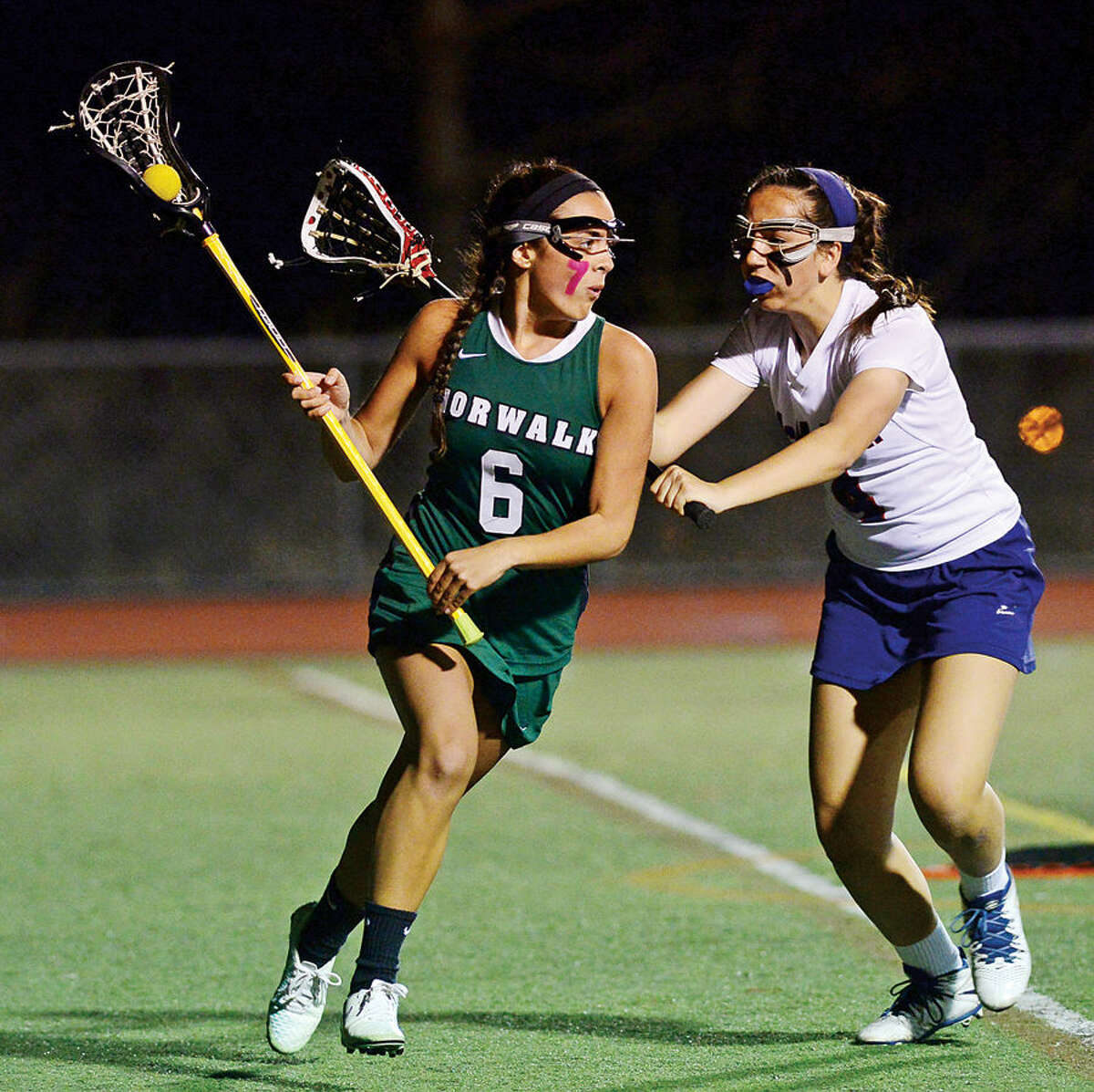 Hour photo / Erik Trautmann The Norwalk High School girls lacrosse team squares off against Brien McMahon High School in their inta-city game for the second annual Kuchta Cup.