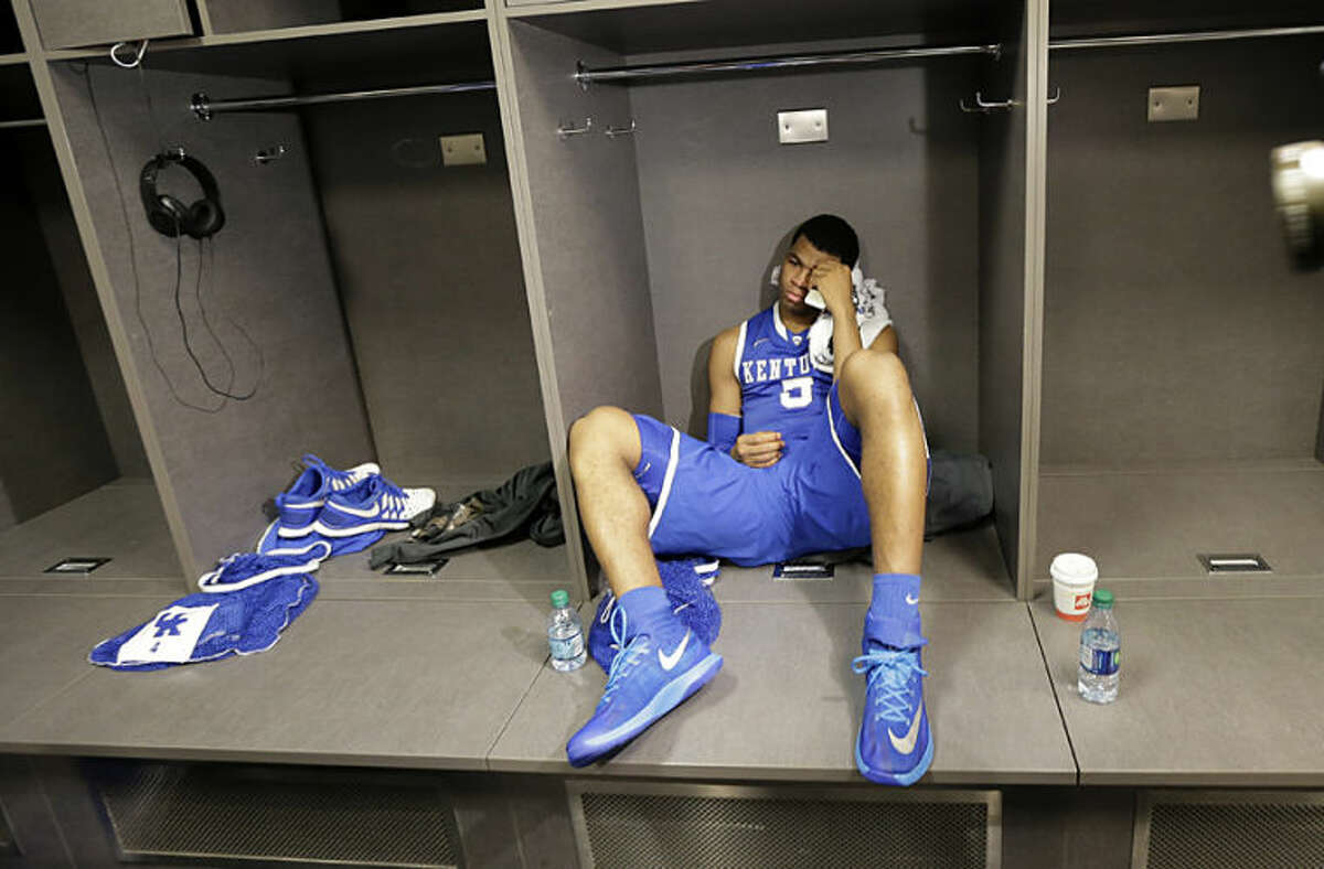 Kentucky guard Andrew Harrison sits in the locker room after his team's 60-54 loss to Connecticut in the NCAA Final Four tournament college basketball championship game Monday, April 7, 2014, in Arlington, Texas. (AP Photo/Eric Gay)