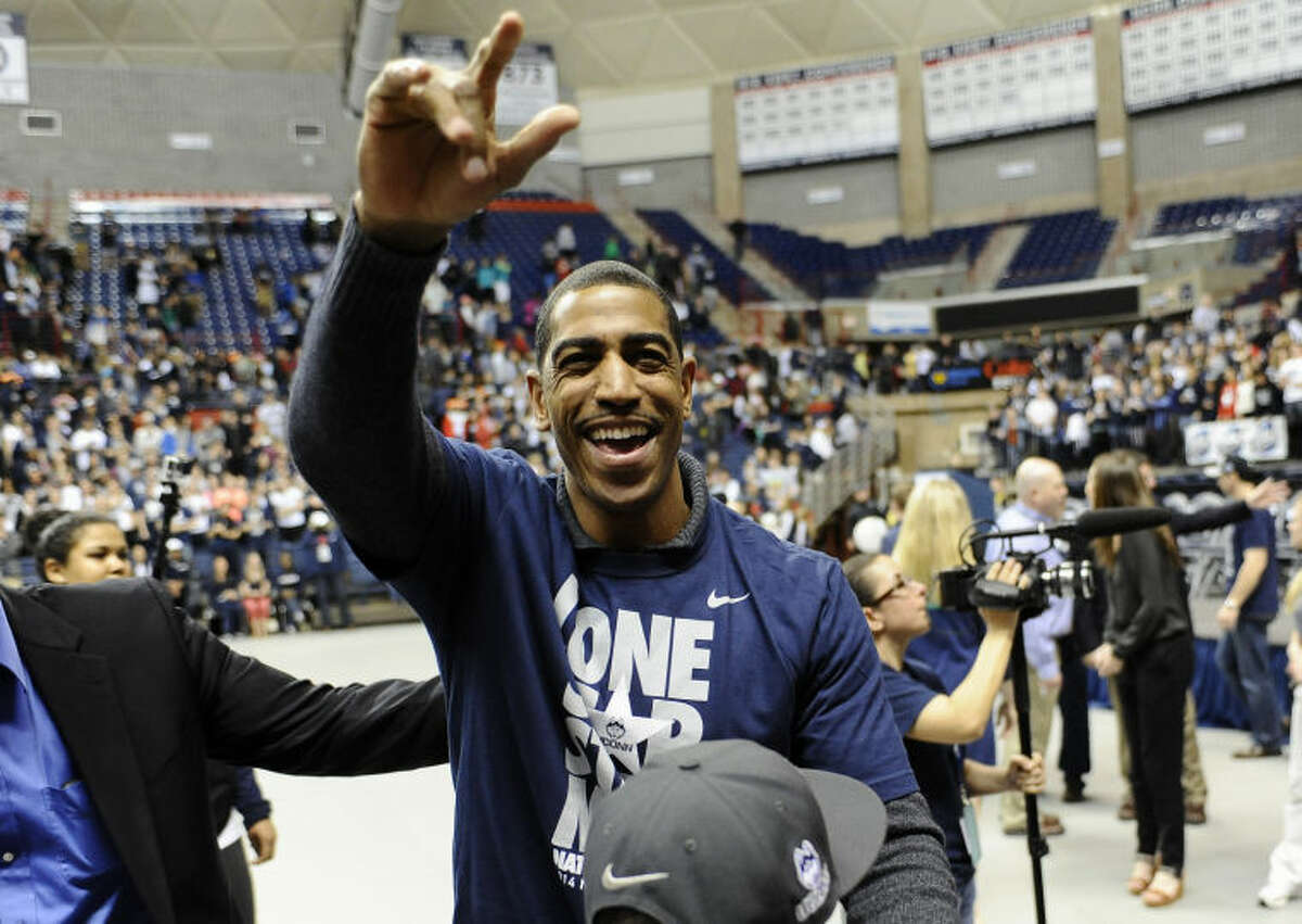 Connecticut head coach Kevin Ollie waves to fans at a pep rally celebrating the program's fourth national championship, Tuesday, April 8, 2014, in Storrs, Conn. (AP Photo/Jessica Hill)