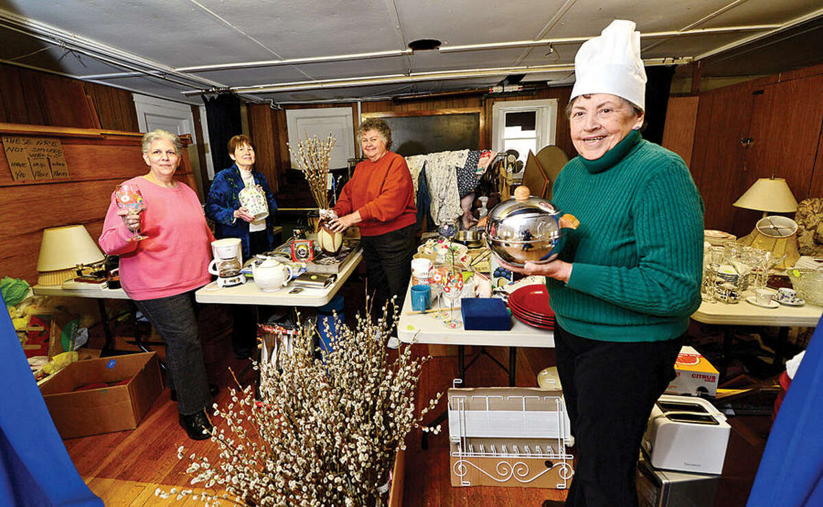 Hour photo / Erik Trautmann Christ Episcopal Church May Fair committee members, Aniat Hughes, Sarah French, Barbara Felterand Barbara Marzolf, set up for its May Fair fundraiser, set for May 2.