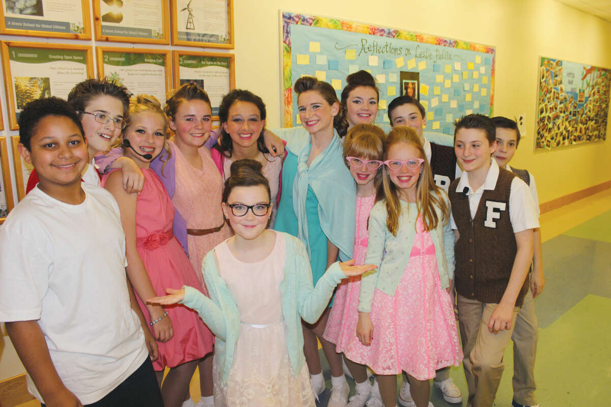 The cast of "Hairspray Jr." gathers backstage after the first night's performance. 