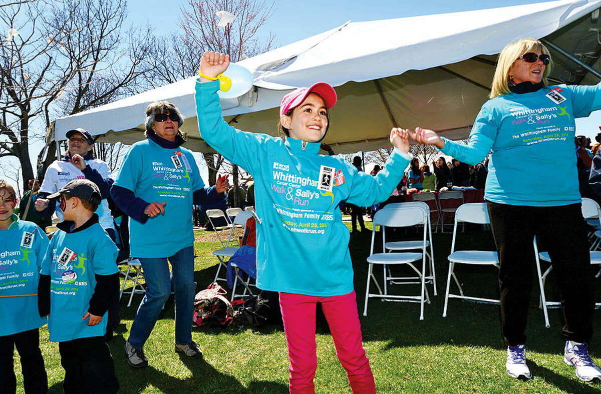 Hour photo / Erik Trautmann 9 year old Adrinna Ording warms up for the Whittingham Cancer Walk and Sally’s Run at Calf Pasture Beach Saturday.