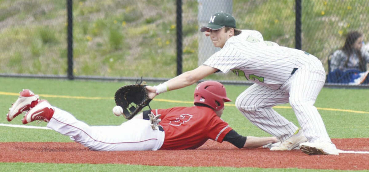 Norwalk first baseman Mike Gonzalez lunges for a pick-off attempt as a Fairfield Prep player dives safely back to first base during Saturday's game in Norwalk. Prep topped the host Bears, 4-0.