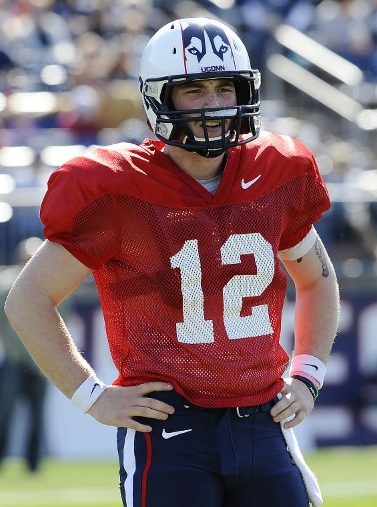 Connecticut quarterback Casey Cochran listens to instructions from a coach during the first half of UConn's Blue-White spring NCAA college football game at Rentschler Field, Saturday, April 12, 2014, in East Hartford, Conn. (AP Photo/Jessica Hill)