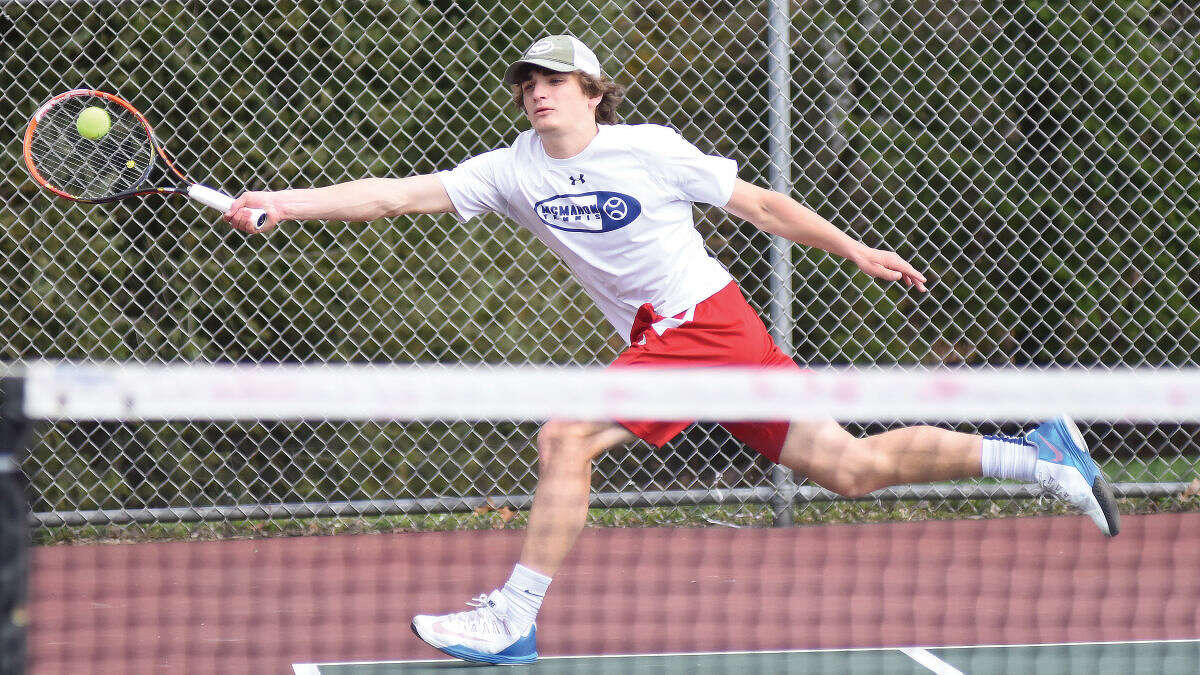 Hour photo/John Nash - Brien McMahon's Zach Ely extends for a return during his No. 1 singles match against Norwalk on Monday.