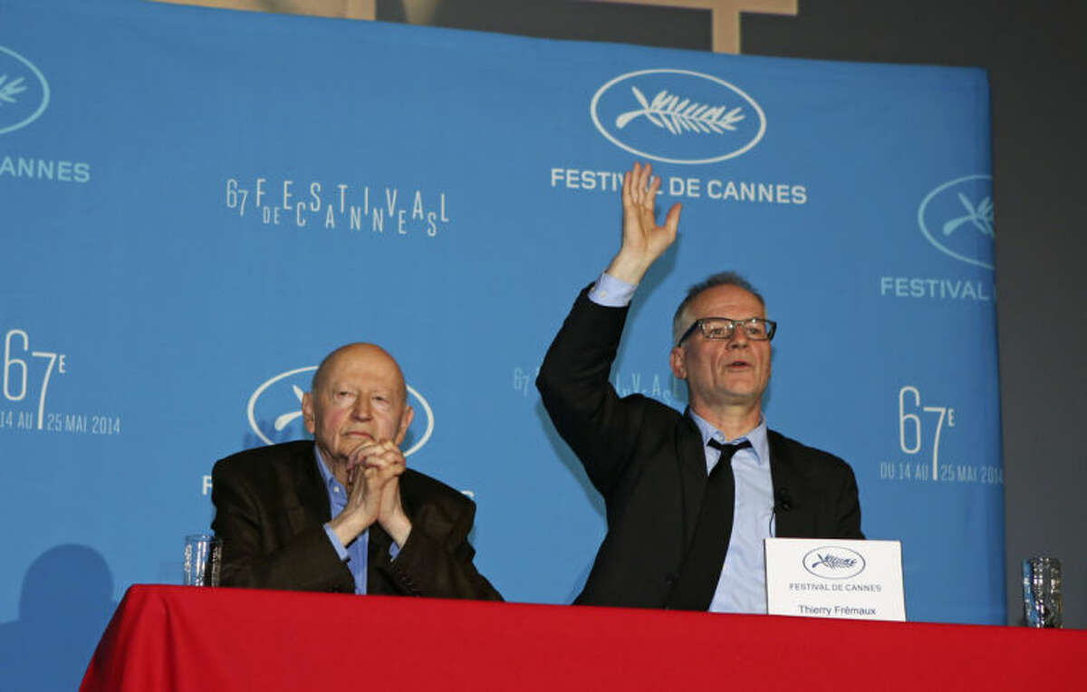 Cannes Film Festival general delegate Thierry Fremaux, right, addresses reporters, as Festival President Gilles Jacob, left, looks on, during a press conference to announce this years line up in Paris, Thursday April 17, 204. A Tommy Lee Jones western and a David Cronenberg exposé on Hollywood are among the 18 films vying for the top prize at the Cannes Film Festival. The festival organizers also said Thursday that two women directors and famed New Wave filmmaker Jean-Luc Godard will be in competition at the festival that runs May 14-25. (AP Photo/Remy de la Mauviniere)