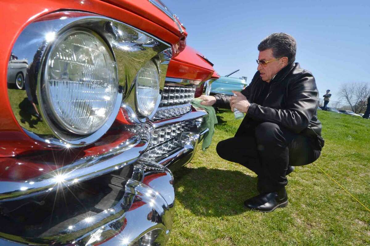 Stamfords Don Corbo helps his friend by polishing the front grille of his all original 1959 Series 62 Cadillac at the 42nd Annual Gateway Antique Auto Show at Taylor Farm on Sunday in Norwalk Conn. April 24 2016