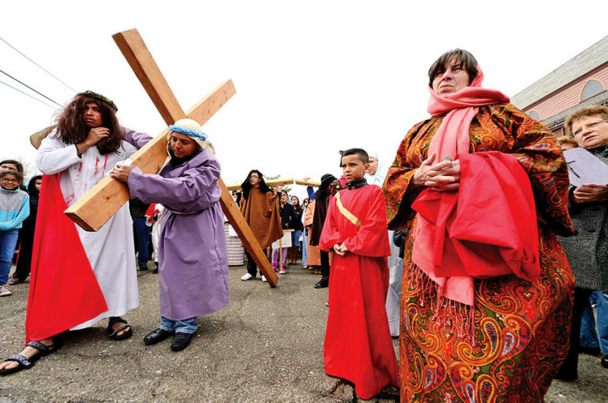 Hour photo / Erik Trautmann Parishioners at St. Josephs Church in South Norwalk follow the Stations of the Cross on Good Friday.