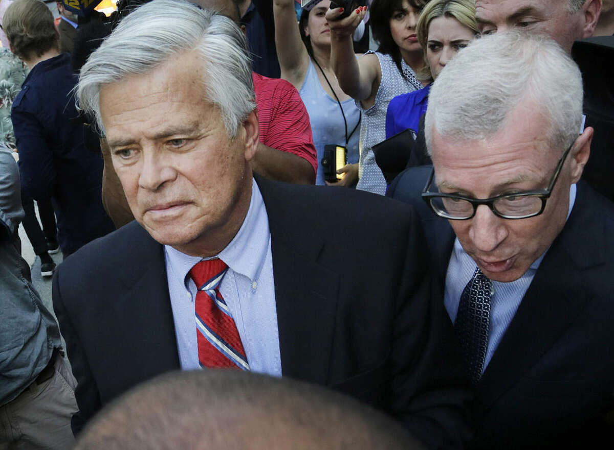 New York Senate Majority Leader Dean Skelos, center, leaves federal court, Monday, May 4, 2015, in New York. Skelos and his son were arraigned on charges including extortion and soliciting bribes amid a federal investigation into the awarding of a $12 million contract to a company that hired his son. (AP Photo/Mark Lennihan)